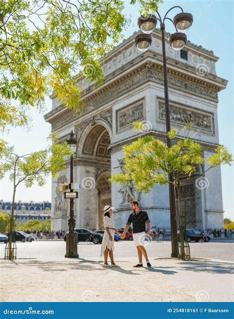 Couple On A Citytrip In Paris Visiting Avenue Des Champs Elysees Paris