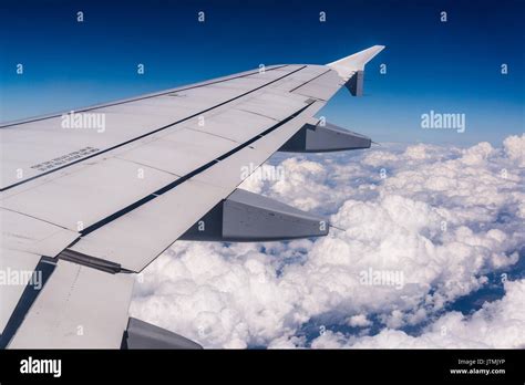 Airplane flying above clouds Stock Photo - Alamy