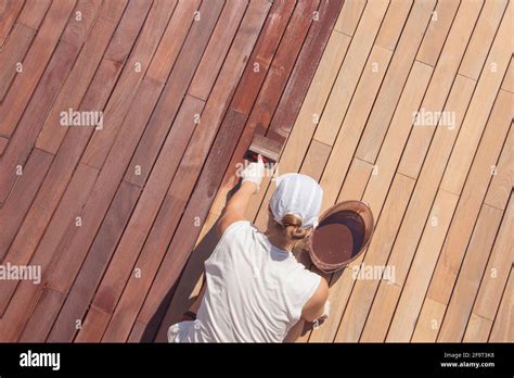 Oil Decking Timber The Person Applying Wood Stain Oil With A Brush