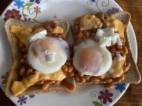 Baked Beans On Toast With A Poached Egg And Ripped Cheese Slices Featuring Ugly Floral Plate