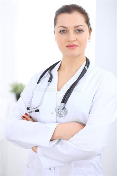 Brunette Female Doctor Standing Straight At Hospital Medicine And Health Care Concept Stock