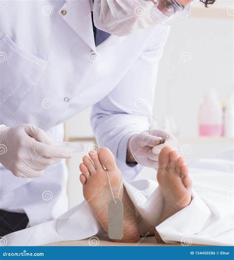 Police Coroner Examining Dead Body Corpse In Morgue Stock Photo Image