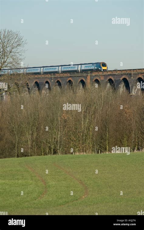 Class 222 Meridian Train In Midland Mainline Livery Travelling Across A Viaduct In The Middle Of