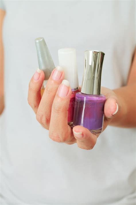 Female Hand With Nail Varnish Bottles Stock Photo Image Of Glamour