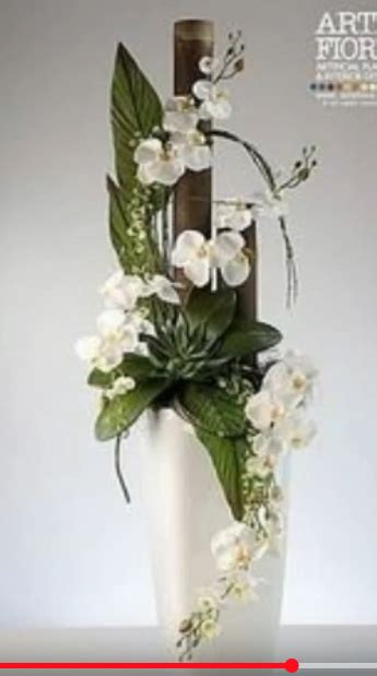 A White Vase With Flowers And Greenery On The Bottom Is Shown In An Ad