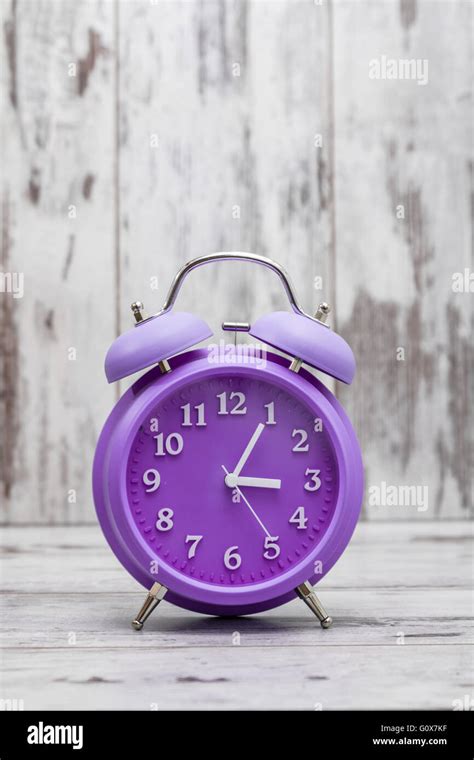 Purple Retro Alarm Clock On White Wooden Background Stock Photo Alamy