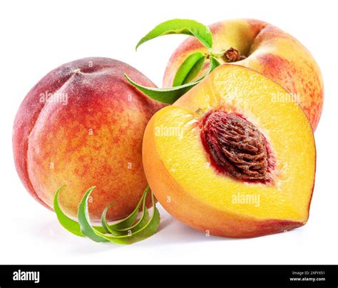 Ripe Juicy Peach Half And Two Peaches With Green Leaves Isolated On