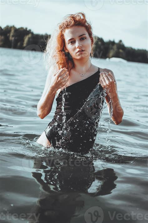 Young beautiful woman standing in the water. 3305322 Stock Photo at ...