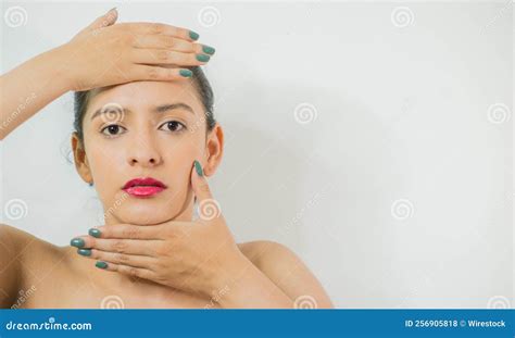 Pretty Young Woman Posing With Her Hands On Her Head On A Blank