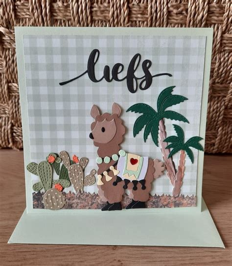 A Card With An Image Of A Llama And Cacti