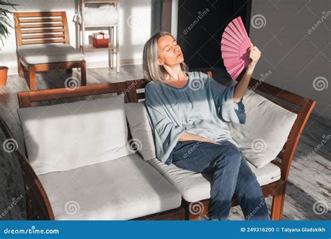 Exhausted Middle Aged Woman Using Paper Waver Suffering From Hot