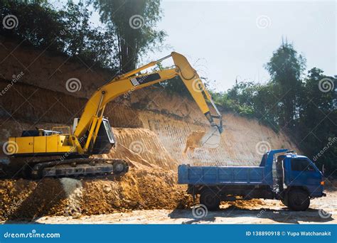 Industrial Excavator And Truck Working On Construction Site Stock Photo