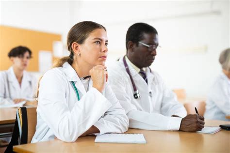 Young Female Doctor Trainee Listening To Lecture During Refresher