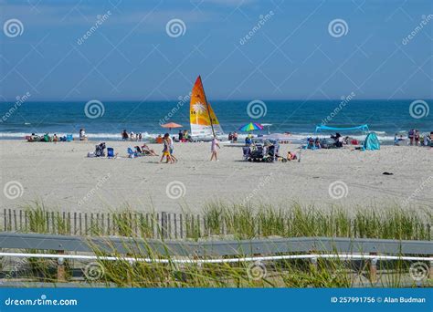 People And A Sailboat On A Beautiful White Sand Beach By The Ocean Editorial Photo Image Of