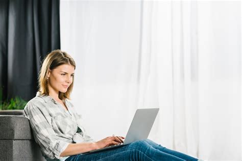 Free Photo | Smiling woman with coffee using laptop