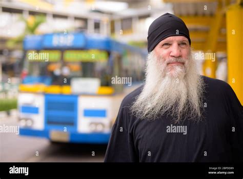 Mature Handsome Bearded Hipster Man Thinking At The Bus Stop Stock