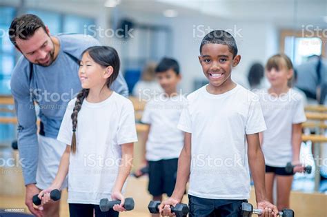 Kids Lifting Weights Stock Photo - Download Image Now - Boys, African ...