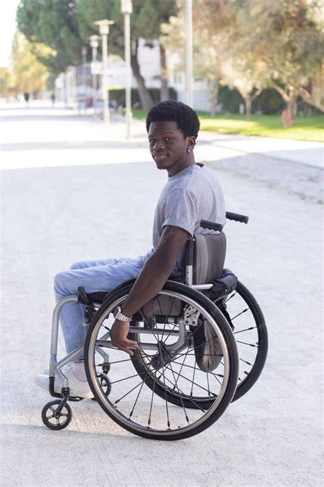 Premium Photo Young Black Man In Wheelchair Enjoying Warm Summer Day