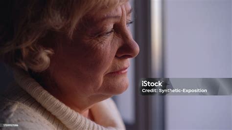 A Sad Old Woman Crying Near The Window Alone Facing Poverty In Her