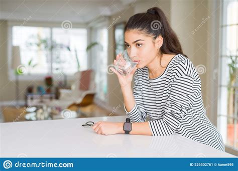 Beautiful Young Woman Drinking A Fresh Glass Of Water At Home Stock