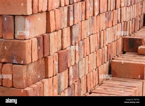 Handmade Red And Brown Adobe Bricks Are Stacked And Drying In The Sun