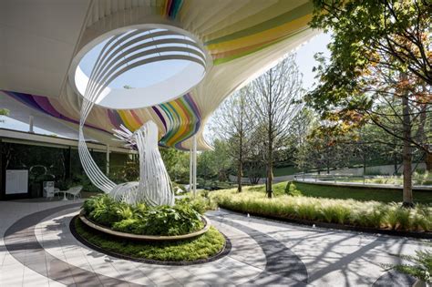 An Artistic Sculpture In The Middle Of A Circular Garden Area With