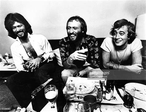 The Bee Gees Posed Sitting At A Table In Amsterdam In 1975 L R Barry