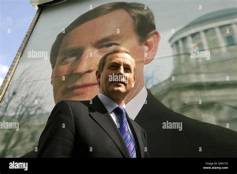 Fine Gael Leader Enda Kenny in front of a poster of himself, outside ...