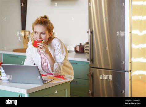 Positive Delighted Blonde Female Eating Her Sandwich Stock Photo Alamy