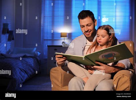 Father Reading Bedtime Story To His Daughter At Home Stock Photo Alamy