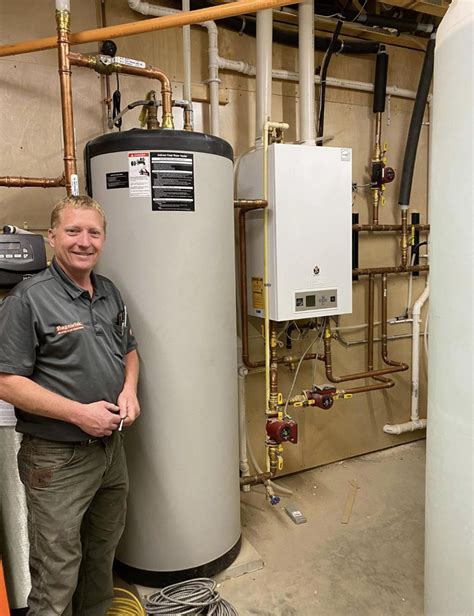 Lance Standing Next To The Ibc High Efficiency Boiler And Indirect