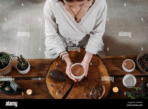 Hot Handmade Ceremonial Cacao In White Cup Woman Hands Holding Craft Cocoa Top View On Wooden