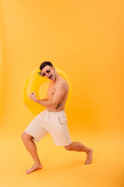 Free Photo Full Length Image Of Cheerful Naked Man In Shorts And Sunglasses