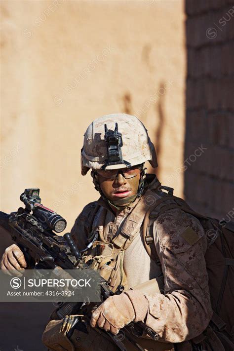 A U.S. Marine, Holding an M249 Squad Automatic Weapon, or SAW, During a Combat Operation in ...