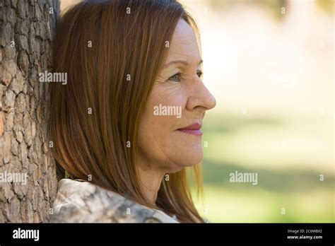 Portrait Attractive Beautiful Mature Woman Sitting Happy Relaxed With Peaceful Smile Outdoors