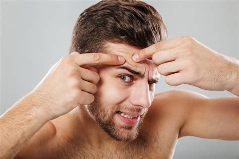 Free Photo Close Up Portrait Of A Man Squeezing Pimple