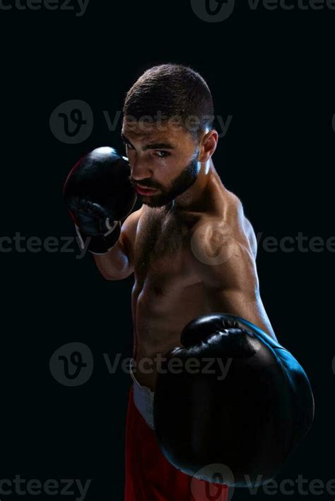 Man Is Hitting An Opponent Focused Fighter With Naked Torso And Boxing Gloves Looking At The