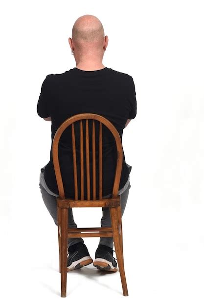 Premium Photo Rear View Of A Bald Man Siiting On A Chair With