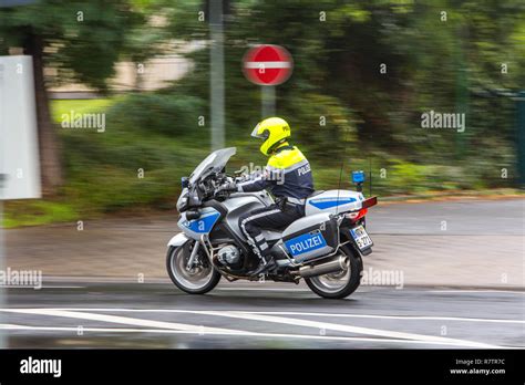 Policeman wearing a yellow helmet on a motorcycle, police motorcycle ...