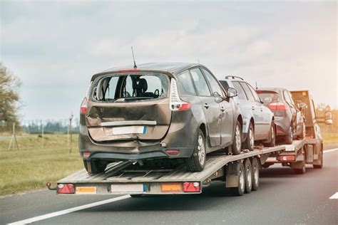 Premium Photo A Car On A Trailer Is Being Towed By A Tow Truck