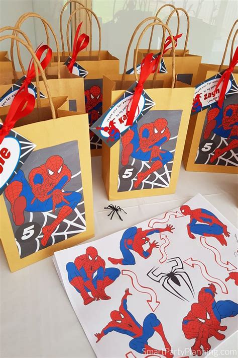 Spiderman Party Bags With Red Blue And Yellow Paper Tags Tied To The