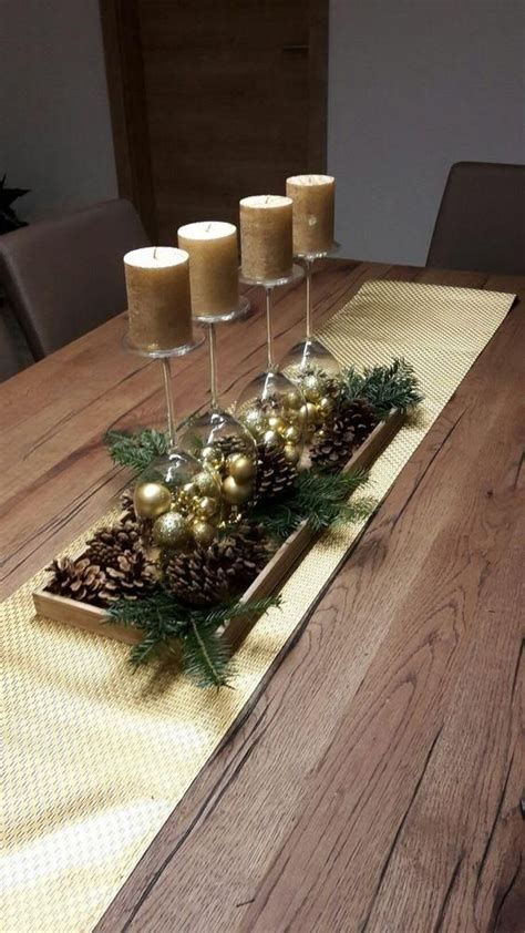 A Table With Candles And Pine Cones On It