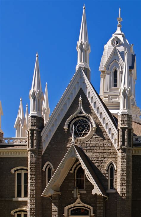 An Old Church With Steeples And A Clock On The Front Door Is Shown