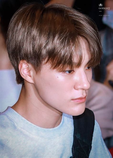 A Young Man With Brown Hair Wearing A Backpack