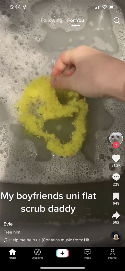 Someone Is Washing Their Hands In The Sink With Yellow Soap And Water