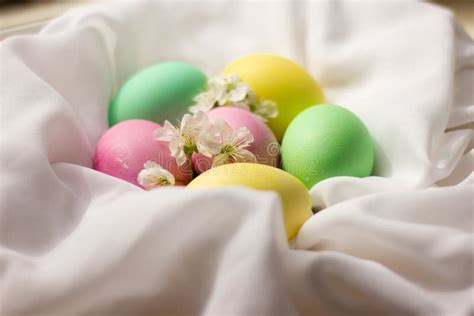 Stylish Easter Eggs And Cherry Blossoms On Rustic Linen Cloth Stock