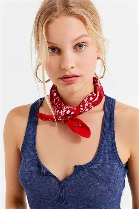 A Woman Wearing A Blue Tank Top With A Red Bandana Around Her Neck And