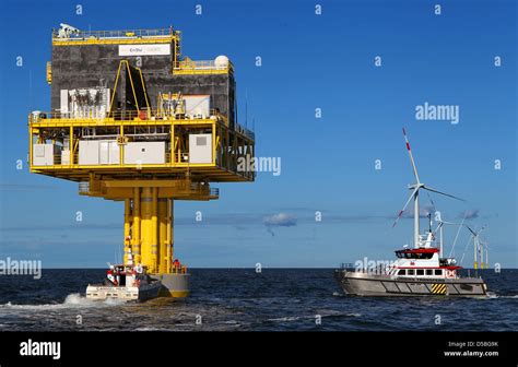 A Working Boat Takes Course On The Wind Turbines Belonging To The