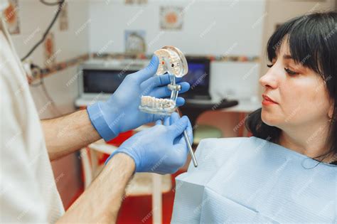 Premium Photo A Male Orthodontist Dentist Shows An Artificial Plastic