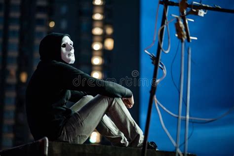 Mystery Man In White Mask Sitting On Rooftop Stock Image Image Of